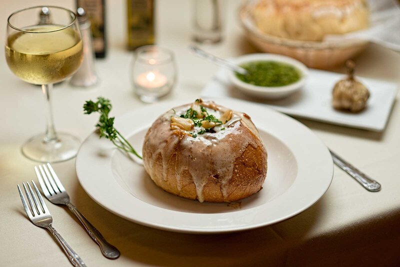 Soup in a bread bowl with white wine and garlic